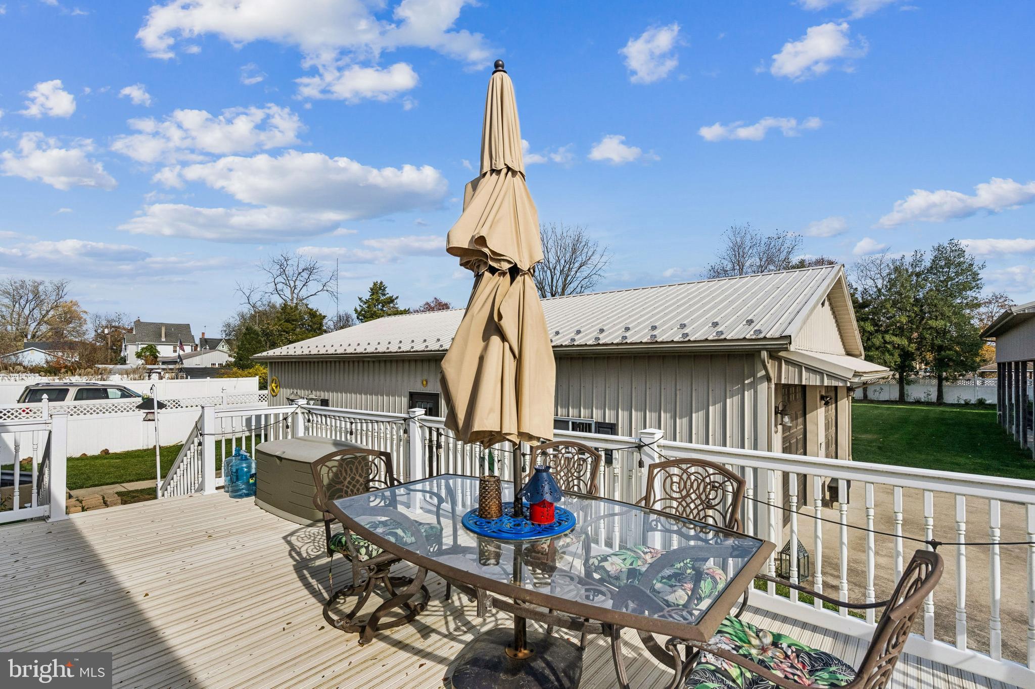 133 Spring Garden Street Woodstown, NJ 08098 - Photo 31 of 50 a table and chairs in front of a house