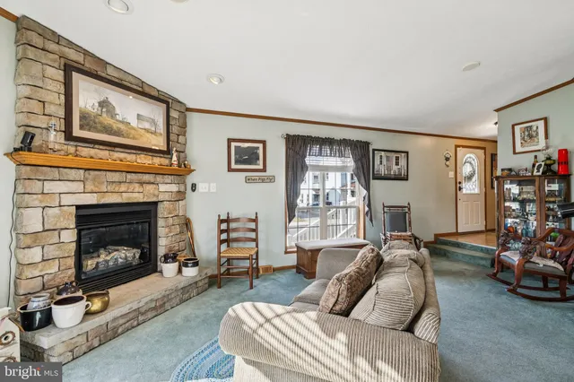 a dining room with stainless steel appliances granite countertop a refrigerator a stove a sink dishwasher a dining table and chairs with wooden floor