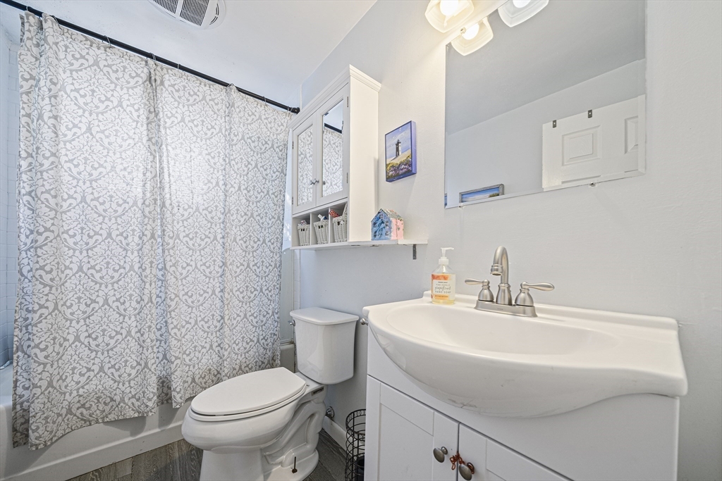 417 Hatherly Road Scituate, MA 02066 - Photo 14 of 25 a bathroom with a sink toilet and a mirror