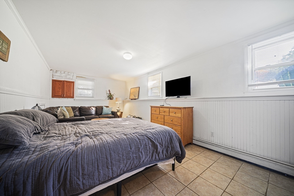 417 Hatherly Road Scituate, MA 02066 - Photo 16 of 25 a spacious bedroom with a bed and flat screen tv