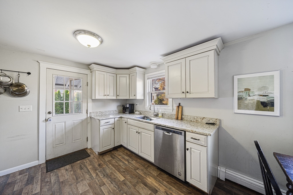 417 Hatherly Road Scituate, MA 02066 - Photo 9 of 25 a kitchen with white cabinets a sink stove and refrigerator