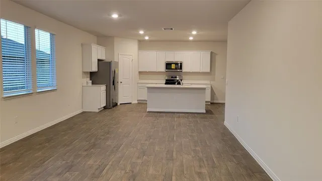 a kitchen with stainless steel appliances a refrigerator sink and stove