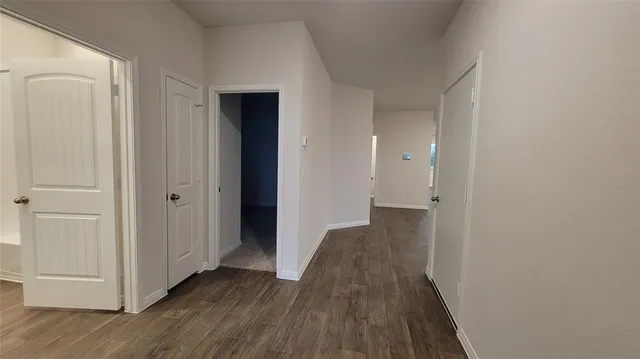 a kitchen with a sink cabinets and wooden floor
