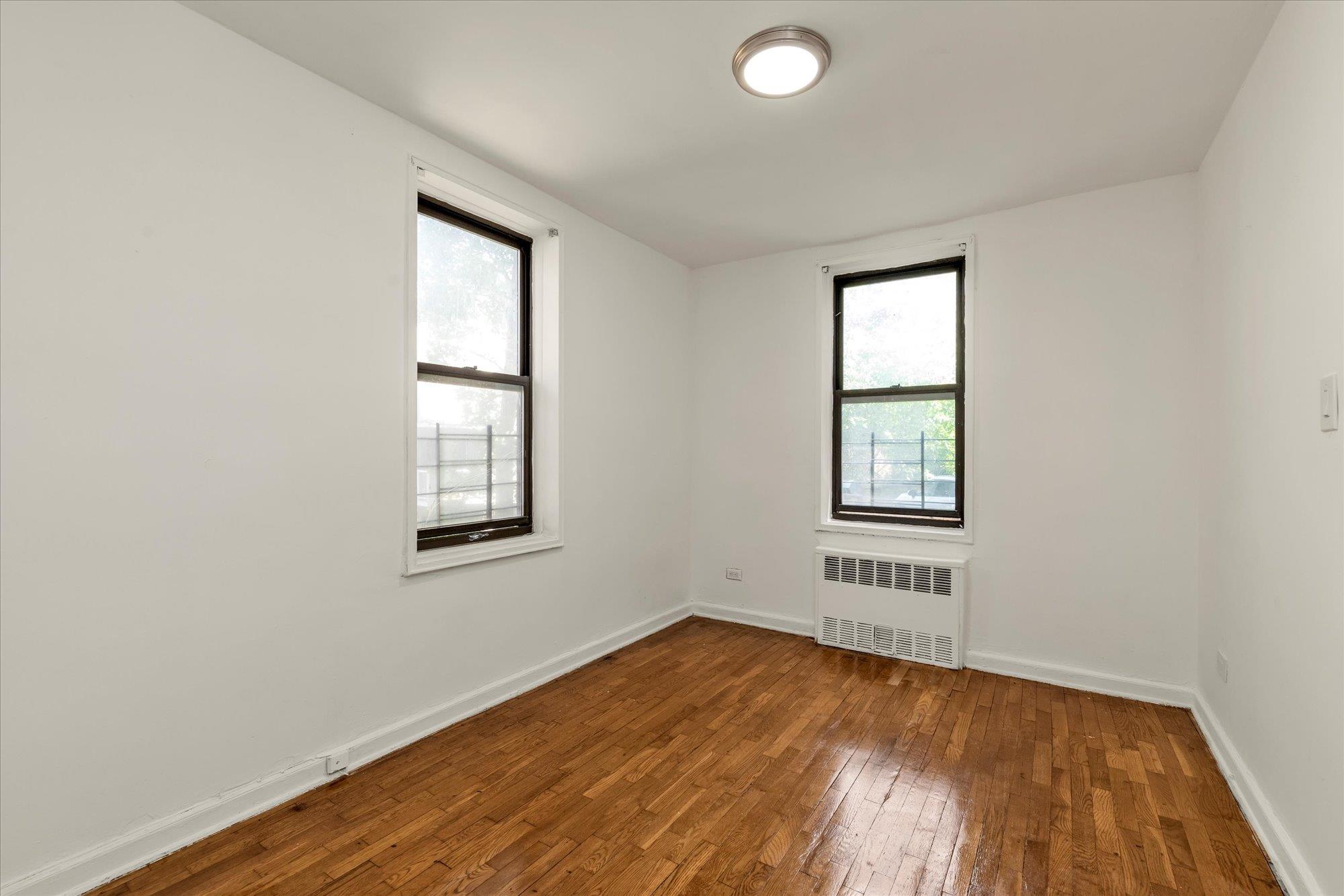 141-05 Pershing Crescent, Unit 117 Queens, NY 11435 - Photo 12 of 16 an empty room with a window