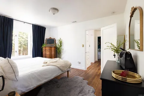 a bedroom with a bed and a couch