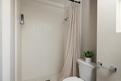 a bathroom with a toilet a sink and a shower