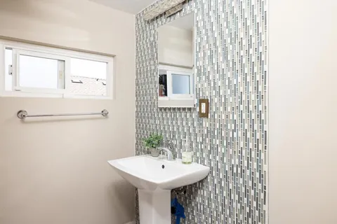 a bathroom with a sink a mirror and shower