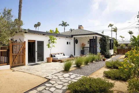a group of people sitting in front of a house