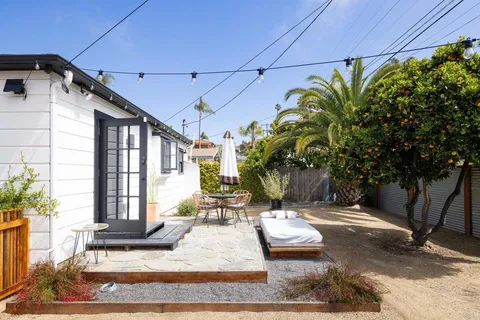 a view of a patio with table and chairs and potted plants