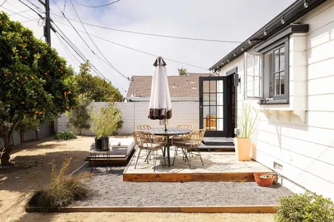 a view of a street with potted plants