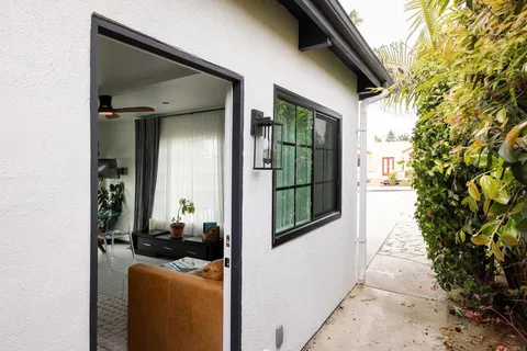 a bedroom with a large bed and a potted plant