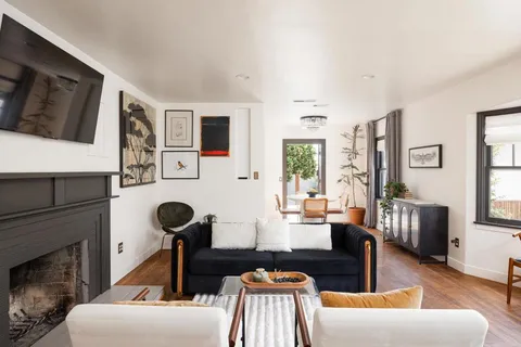 a living room with furniture fireplace and flat screen tv