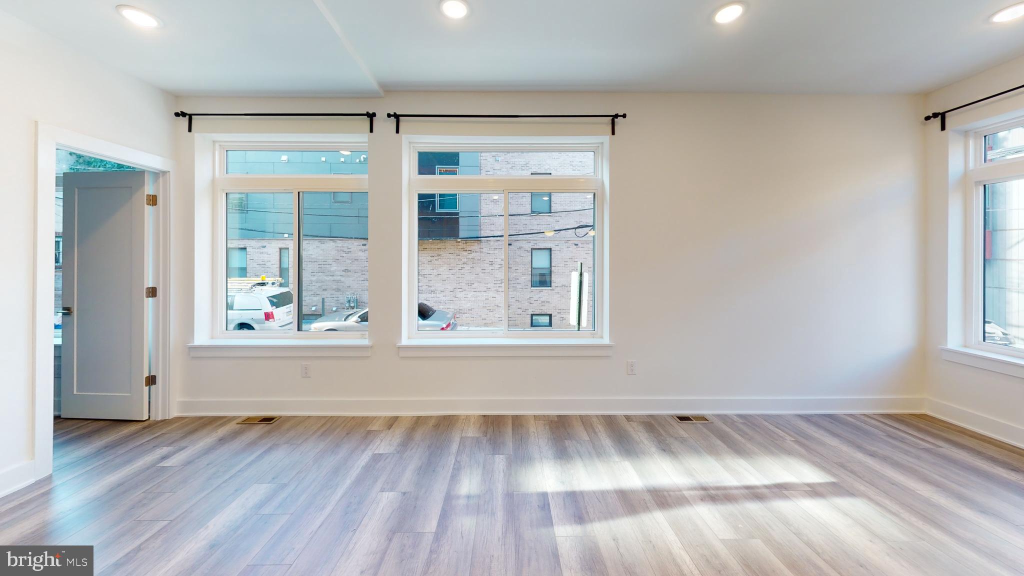 812 North 16th Street, Unit 3 Philadelphia, PA 19130 - Photo 3 of 17 a view of an empty room with wooden floor and a window
