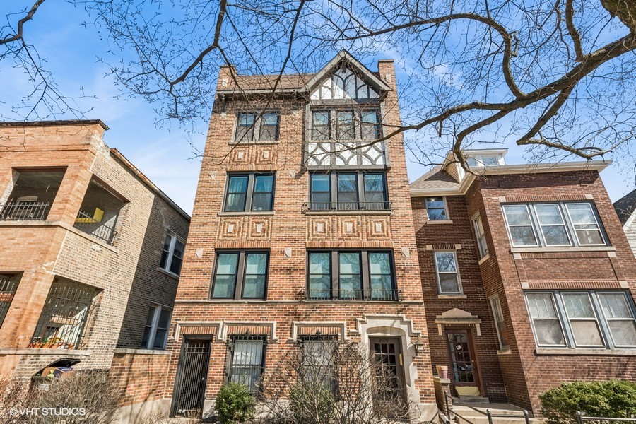 4909 North Janssen Avenue, Unit GDN Chicago, IL 60640 - Photo 1 of 8 a front view of a residential apartment building with a yard