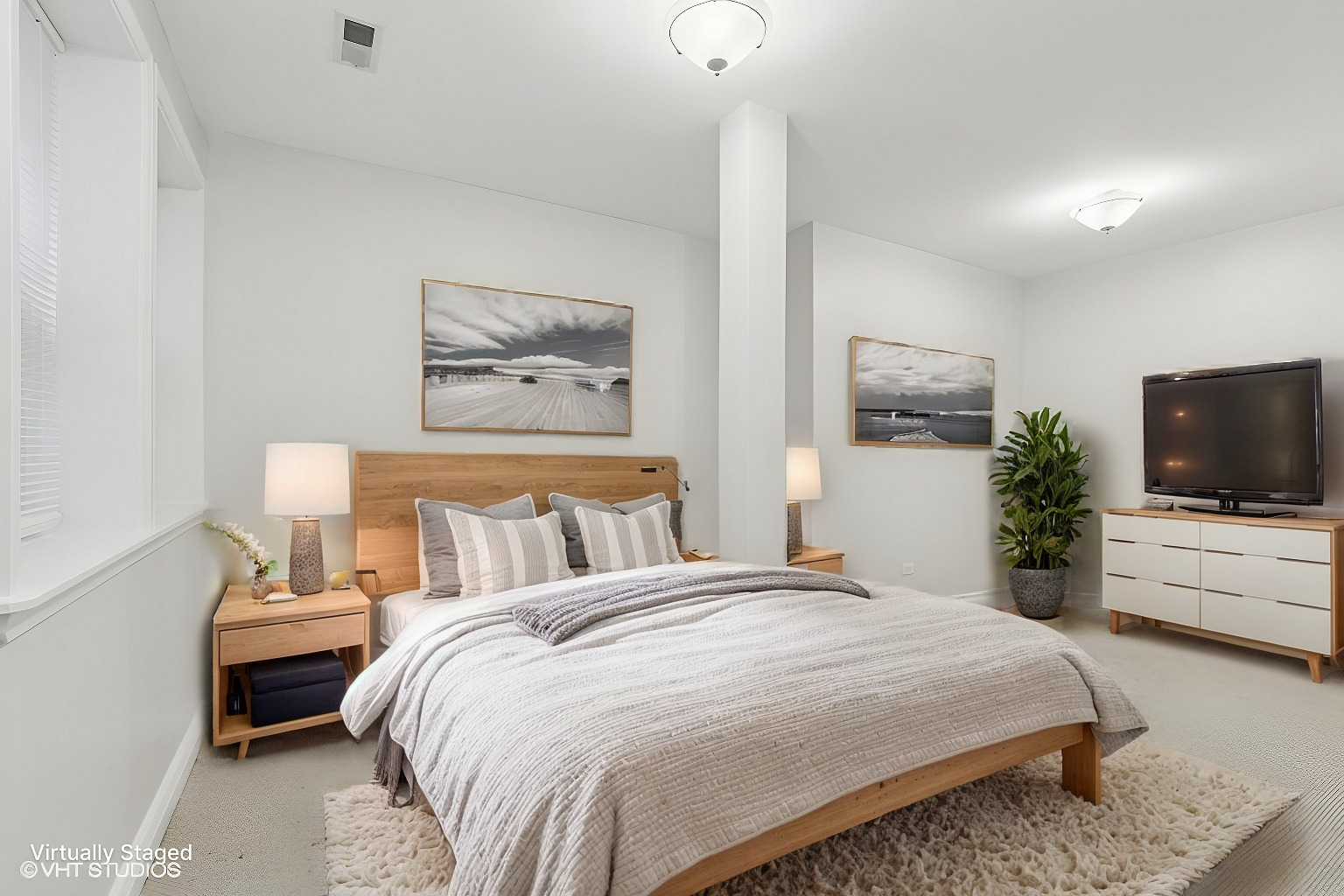 4909 North Janssen Avenue, Unit GDN Chicago, IL 60640 - Photo 6 of 8 a bedroom with a bed a mirror and a flat screen tv