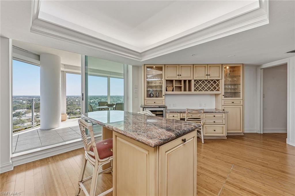 60 Seagate Drive, Unit 1606 Naples, FL 34103 - Photo 11 of 44 a view of a kitchen counter space and wooden floor