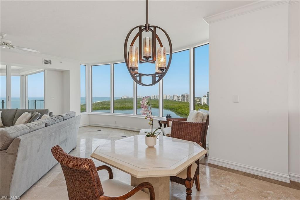 60 Seagate Drive, Unit 1606 Naples, FL 34103 - Photo 12 of 44 a view of an dining room with furniture window and outside view