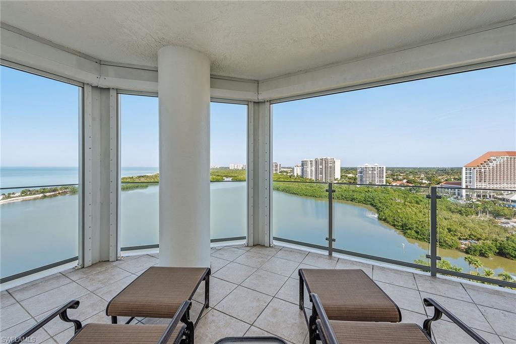 60 Seagate Drive, Unit 1606 Naples, FL 34103 - Photo 20 of 44 a living room with a floor to ceiling window and furniture