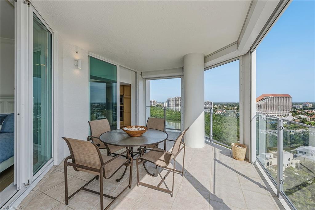 60 Seagate Drive, Unit 1606 Naples, FL 34103 - Photo 27 of 44 a dining room with furniture and large windows
