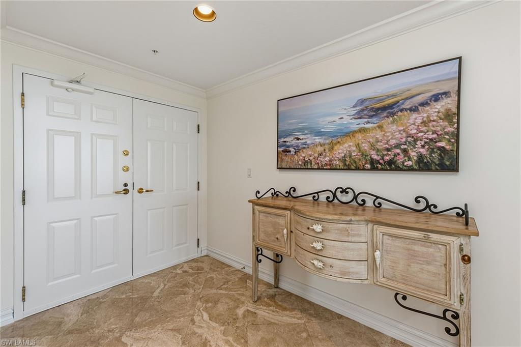 60 Seagate Drive, Unit 1606 Naples, FL 34103 - Photo 31 of 44 a bedroom with a bed and a painting on the wall