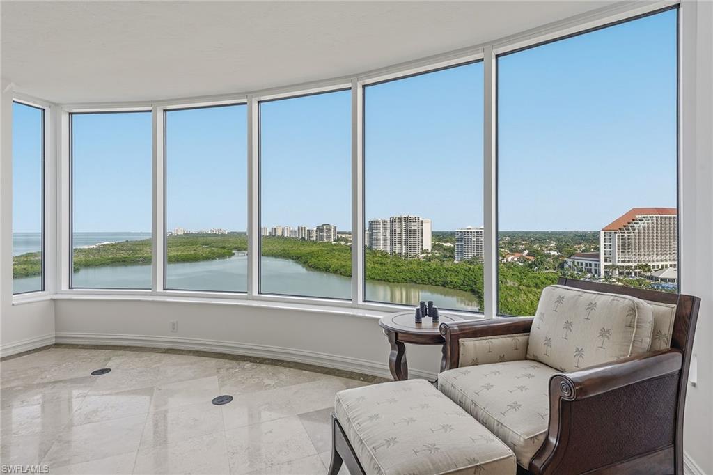 60 Seagate Drive, Unit 1606 Naples, FL 34103 - Photo 6 of 44 a living room with furniture and a floor to ceiling window