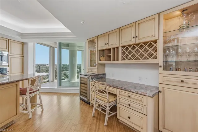 a kitchen with granite countertop white cabinets and a sink
