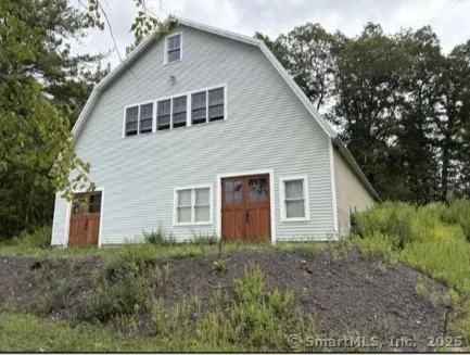 a front view of house with a yard and trees