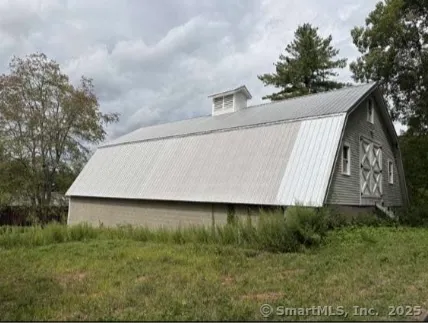 a backyard of a house with lots of green space and trees
