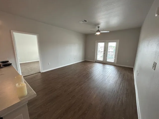 wooden floor in an empty room with a window