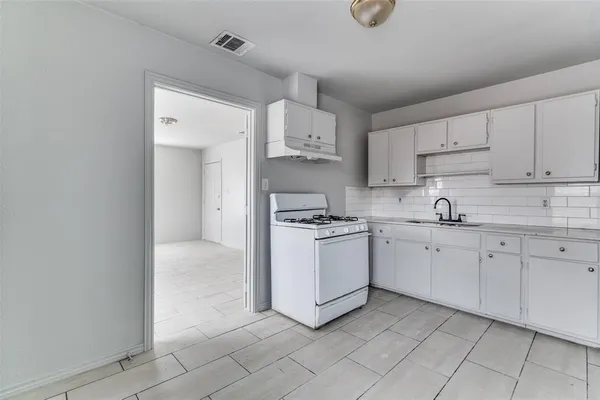 a kitchen with cabinets and window
