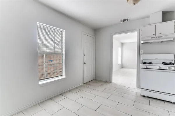 a view of a kitchen with a stove top oven