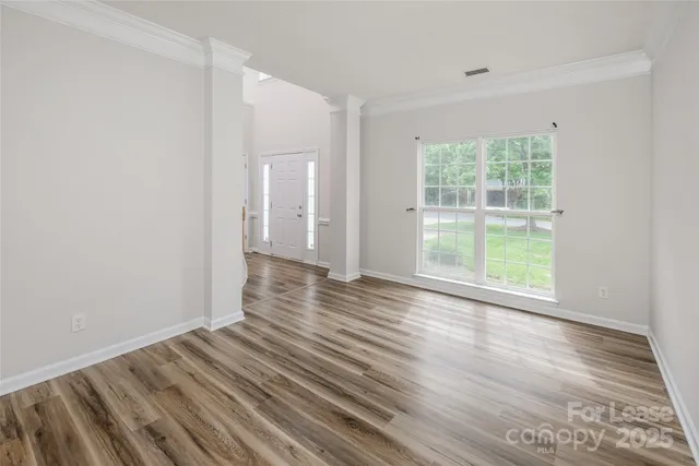 a view of wooden floor and windows in a room