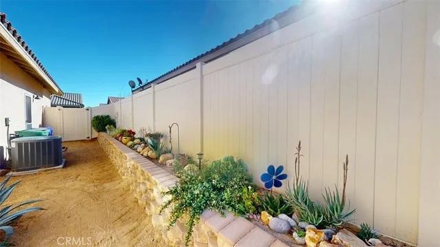 a living room with furniture a flat screen tv and a large window