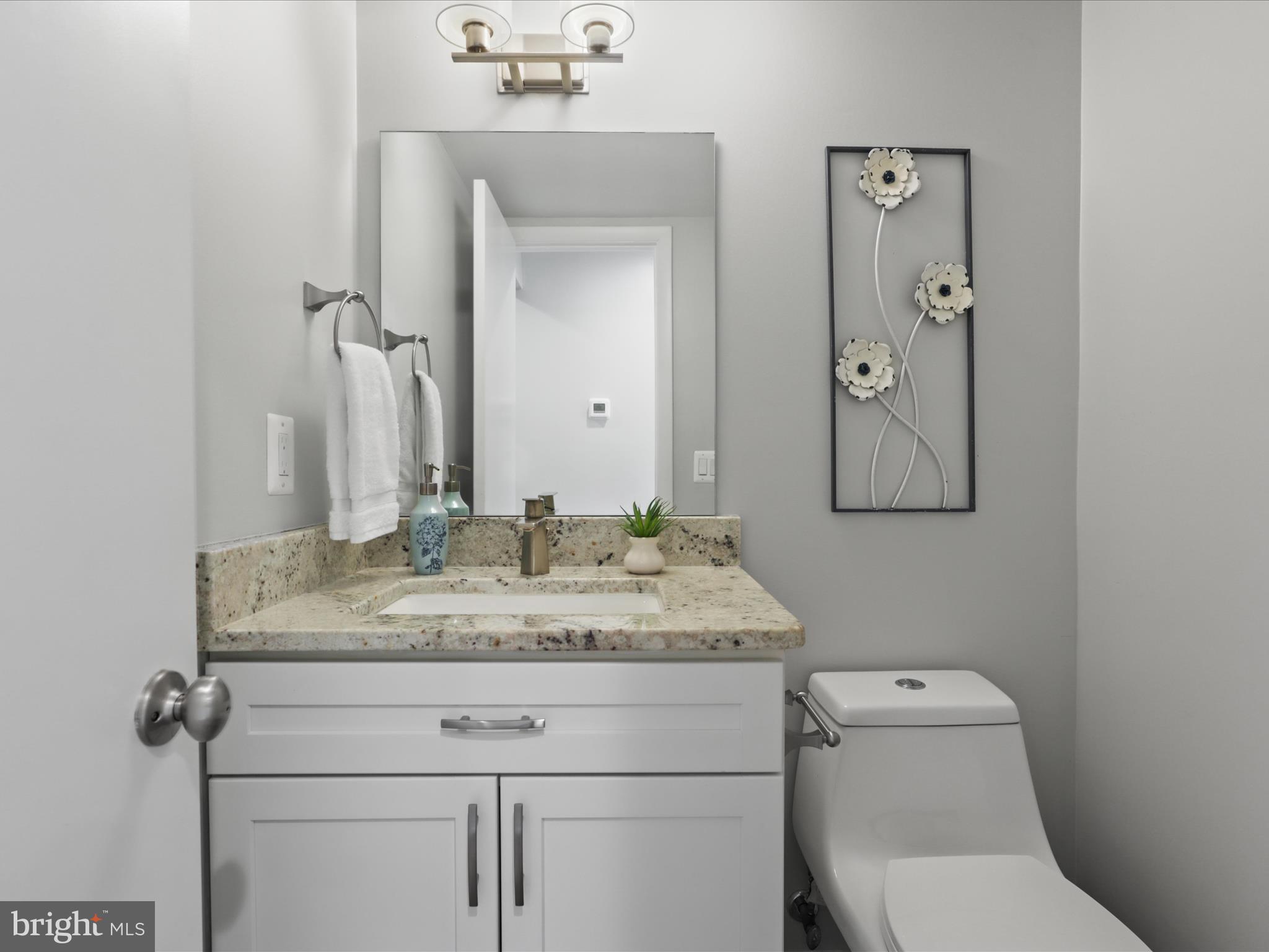 11159 Saffold Way Reston, VA 20190 - Photo 15 of 51 a bathroom with a granite countertop toilet sink and mirror