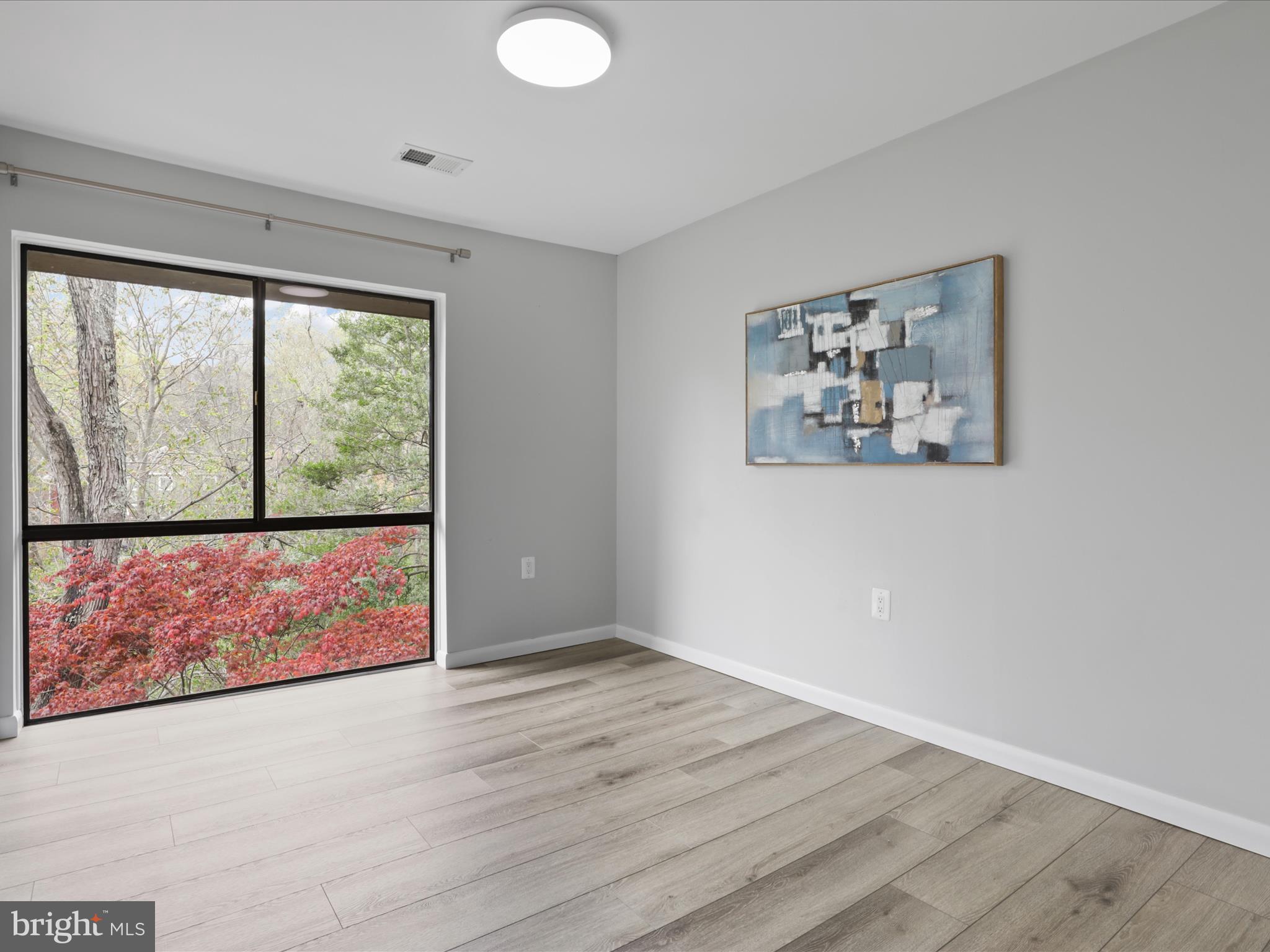 11159 Saffold Way Reston, VA 20190 - Photo 17 of 51 an empty room with wooden floor and window