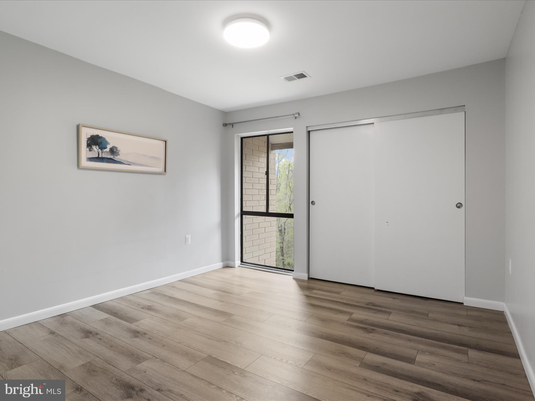 11159 Saffold Way Reston, VA 20190 - Photo 19 of 51 an empty room with wooden floor and mirror