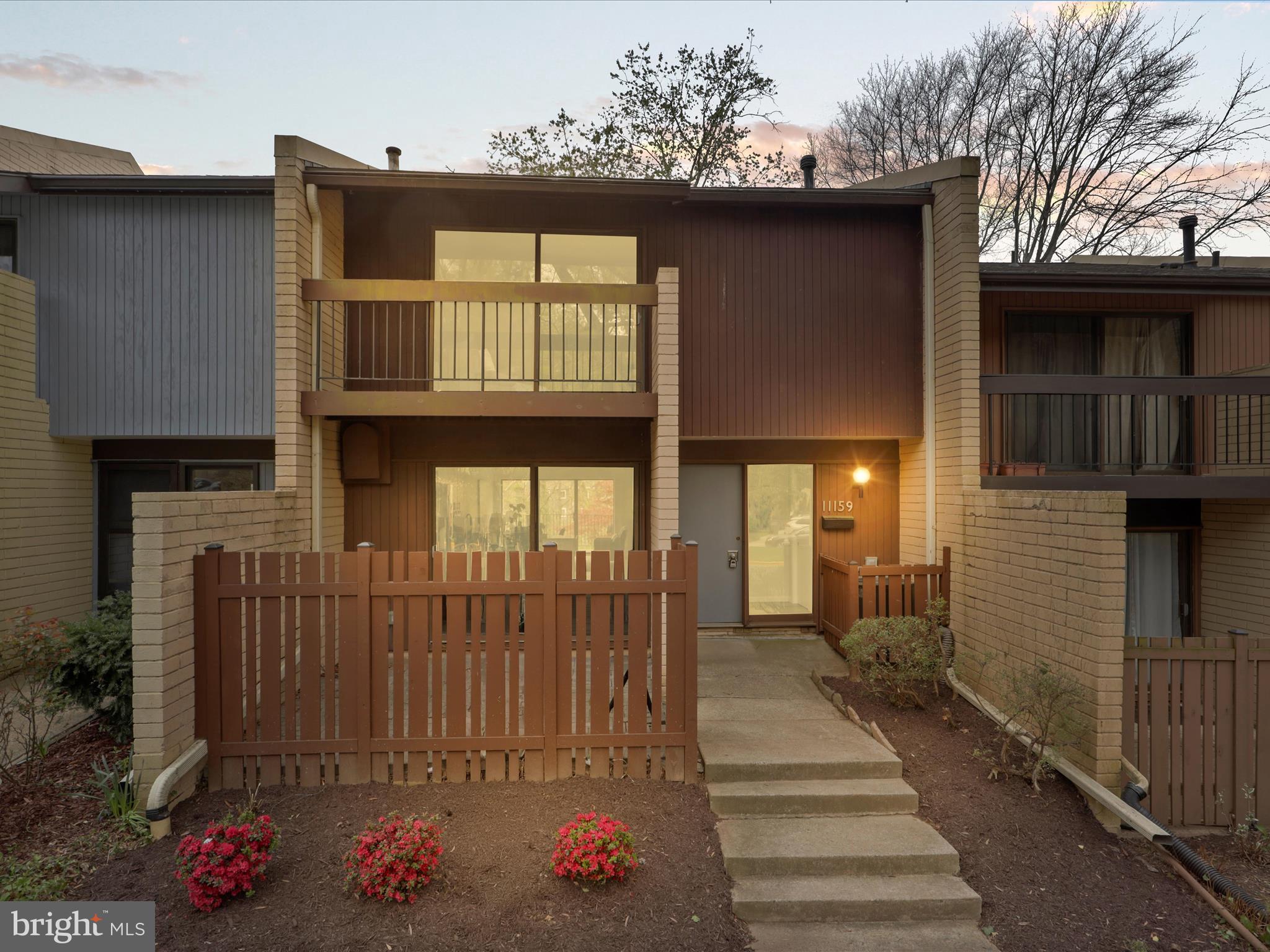 11159 Saffold Way Reston, VA 20190 - Photo 2 of 51 a front view of a house with a porch
