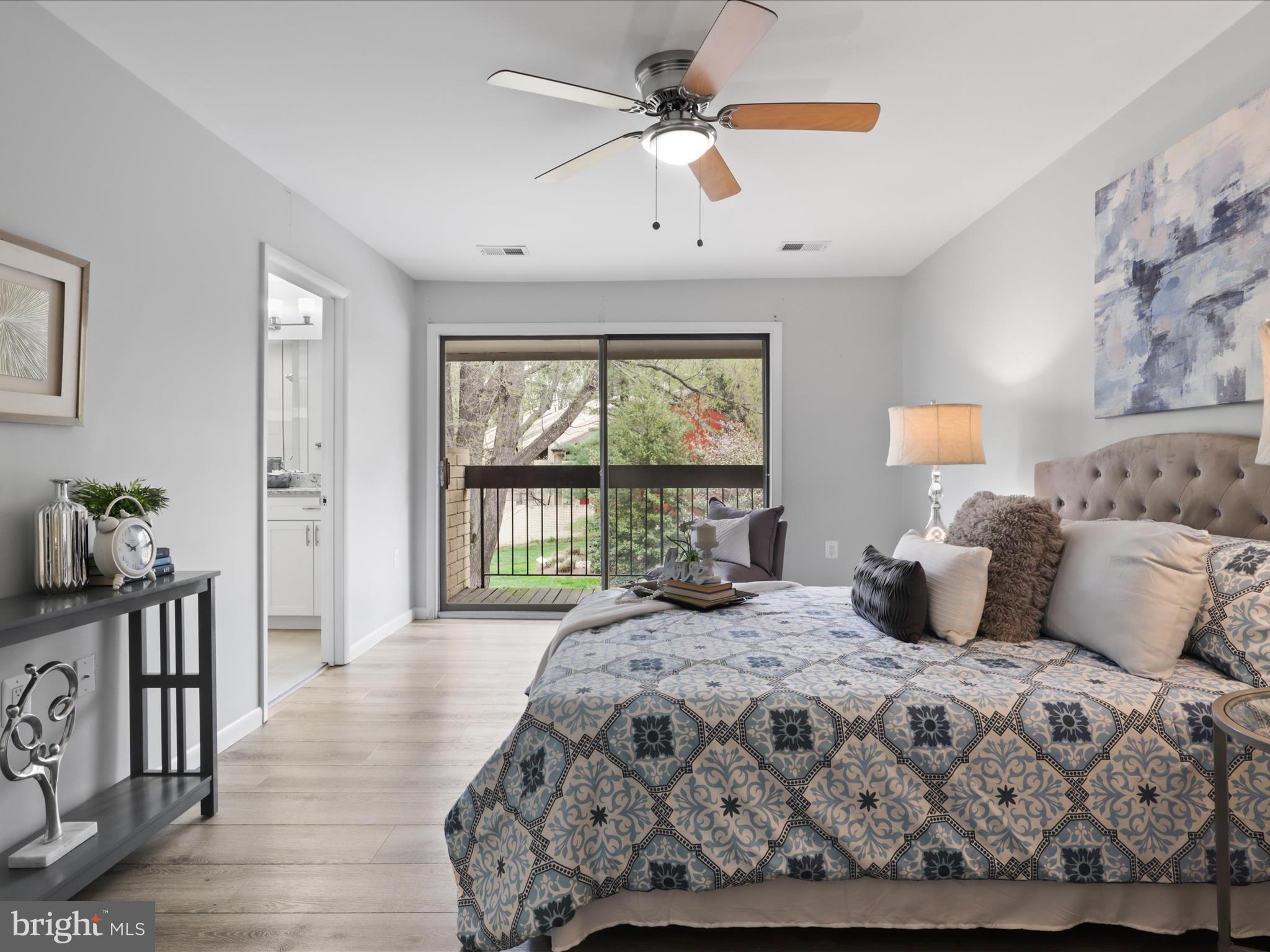 11159 Saffold Way Reston, VA 20190 - Photo 21 of 51 a bedroom with a large bed and a chandelier