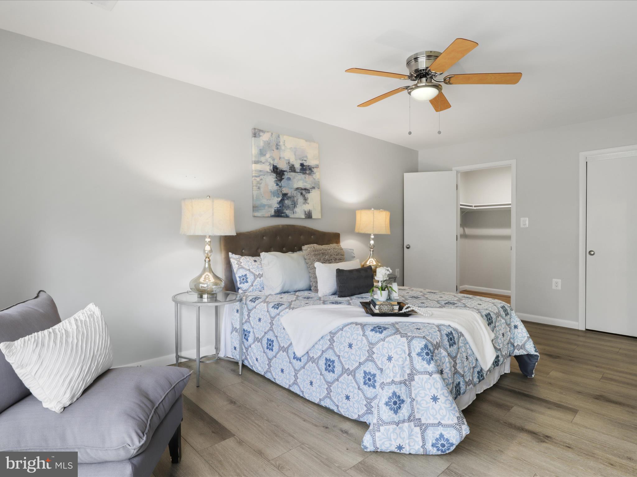 11159 Saffold Way Reston, VA 20190 - Photo 22 of 51 a bedroom with bed and a chandelier