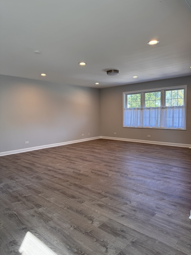 316 Plum Street Lake In The Hills, IL 60156 - Photo 11 of 19 an empty room with wooden floor and windows