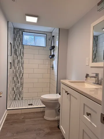 a bathroom with a sink toilet and shower
