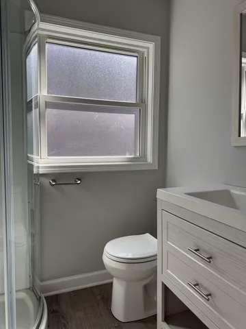 a bathroom with a toilet and a window