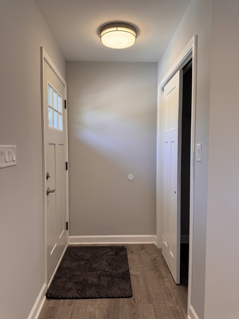 316 Plum Street Lake In The Hills, IL 60156 - Photo 17 of 19 an empty room with wooden floor and a window