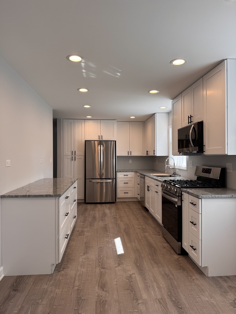 316 Plum Street Lake In The Hills, IL 60156 - Photo 2 of 19 a kitchen with stainless steel appliances kitchen island granite countertop a stove a sink and a refrigerator