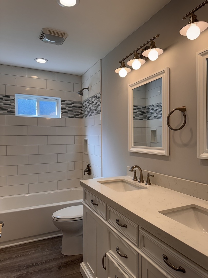 316 Plum Street Lake In The Hills, IL 60156 - Photo 3 of 19 a bathroom with a sink a toilet and shower
