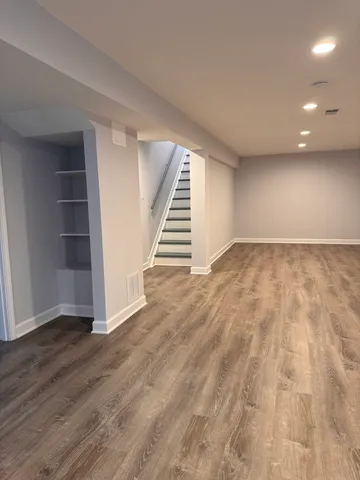 wooden floor in an empty room with a gallery