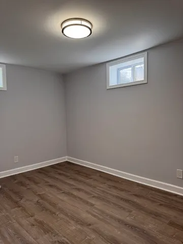 a view of a room with wooden floor and window