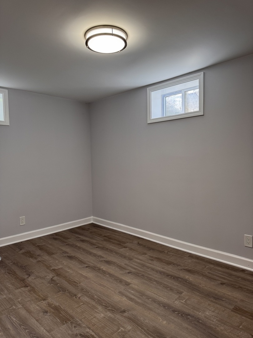 316 Plum Street Lake In The Hills, IL 60156 - Photo 8 of 19 a view of a room with wooden floor and window