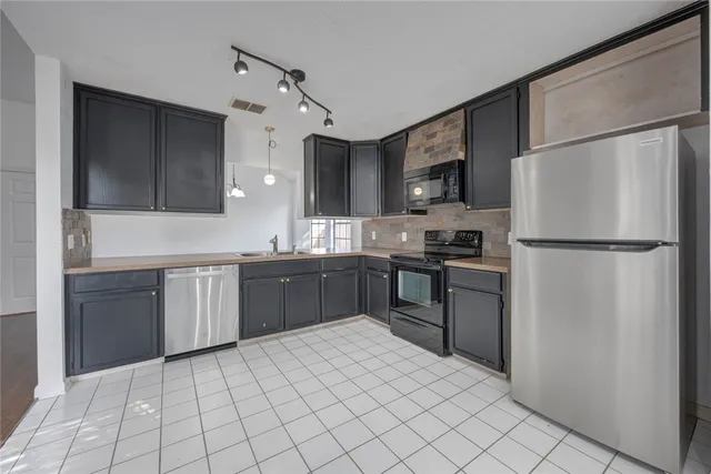 a kitchen with a refrigerator and a sink