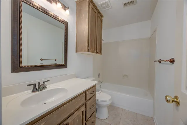 a bathroom with a sink toilet tub and shower